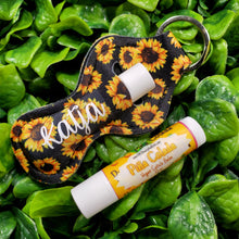 Load image into Gallery viewer, SunKeeper || Black w/Sunflowers || Custom Sunflower Keyring Balm Holder || Neoprene Keychain