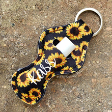 Load image into Gallery viewer, SunKeeper || Black w/Sunflowers || Custom Sunflower Keyring Balm Holder || Neoprene Keychain